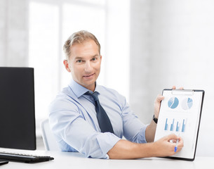 businessman showing graphs and charts