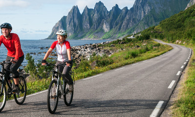 two cyclists relax biking