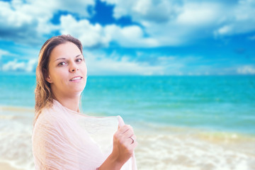 Beautiful lady on the beach holding a scarf