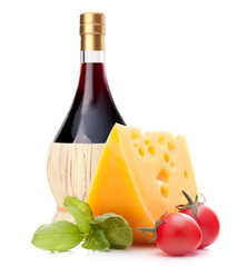 Red wine bottle, cheese and tomato still life