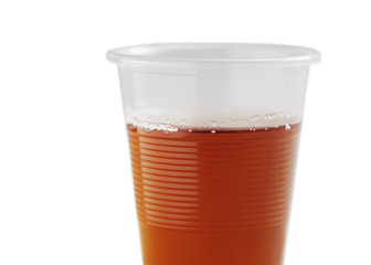 clear plastic cup with tea isolated on white background