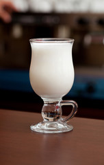 Glass of milk for coffee at the bar