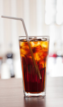 glass of cola with ice on the bar