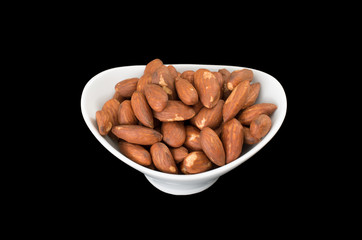 Bowl of almonds on black background