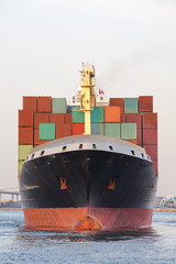 Cargo freight ship with stacked container at harbor terminal