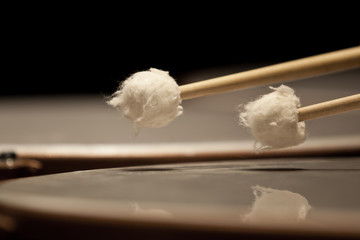 Drum sticks hitting the timpani closeup