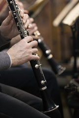 Human hands playing a clarinet closeup