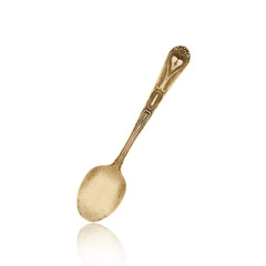 old brass spoon isolated on white background