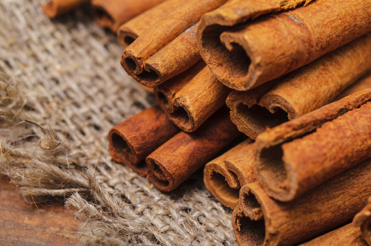 Closeup photo of cinnamon sticks on a linen cloth