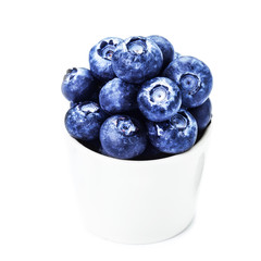 Blueberries in a bowl isolated on white background close up. Gro