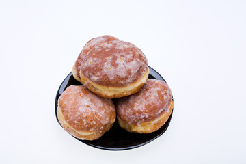 whole donuts on the black porcelain plate
