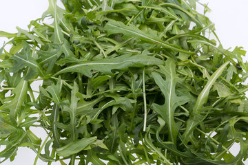 Fototapeta premium Heap of ruccola leaves isolated on white background