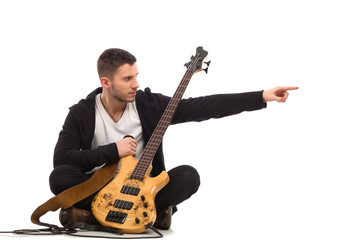 Male musician pointing. Full length studio shot isolated.