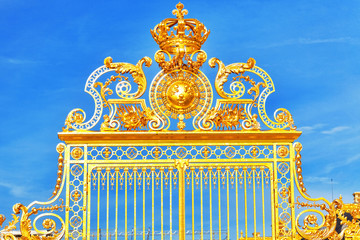 Golden Gate of Chateau de Versailles with blue sky . Paris, Fran