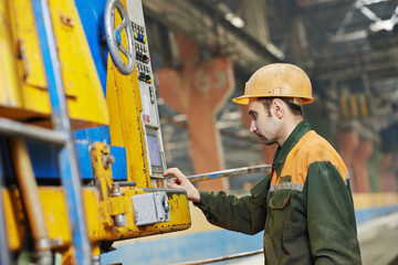 industrial worker operating machine