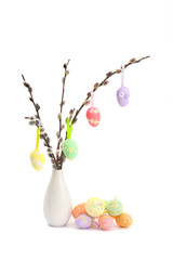 hanging easter eggs on pussy willow twigs © Mariya Pshenina