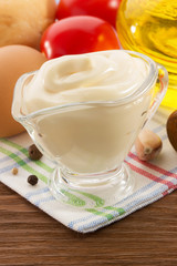 mayonnaise sauce in bowl on wood