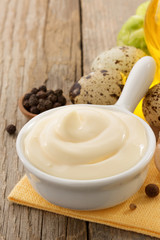 mayonnaise sauce in bowl on wood