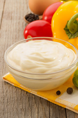 mayonnaise sauce in bowl on wood