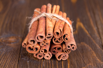 Cinnamon sticks on a wooden background