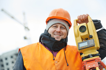Portrait of surveyor worker with theodolite