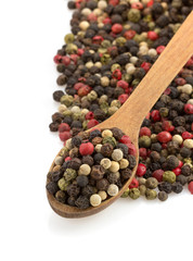 pepper in spoon on white