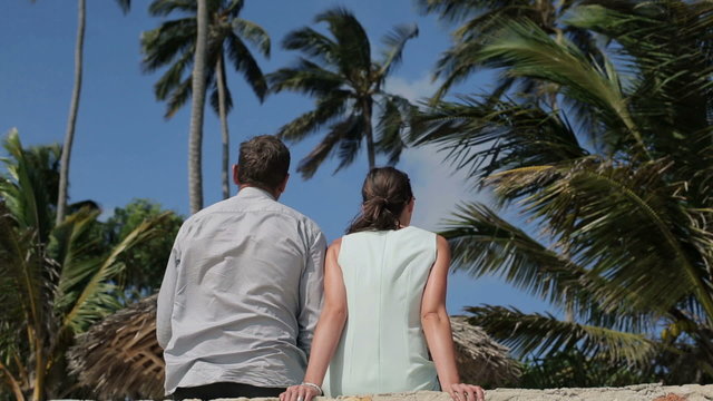 Business Couple Sitting And Relaxing In Exotic Location