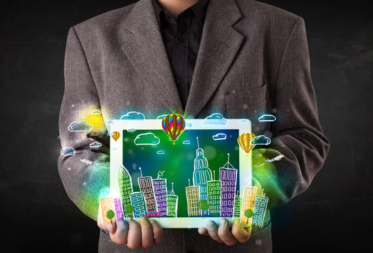 Young person showing tablet with hand drawn cityscape