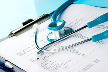 Blood test results in a clipboard with stethoscope