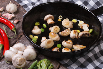 fried mushrooms with leeks in the pan. chilli and garlic
