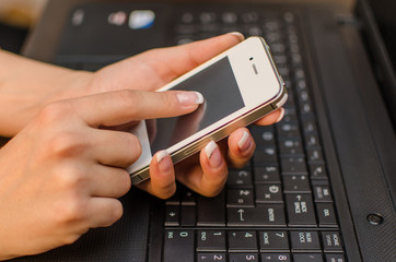Woman with laptop and phone