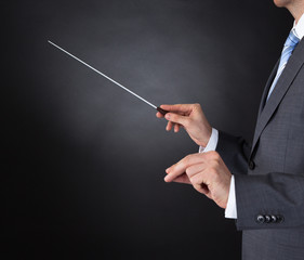 Orchestra Conductor Holding Baton