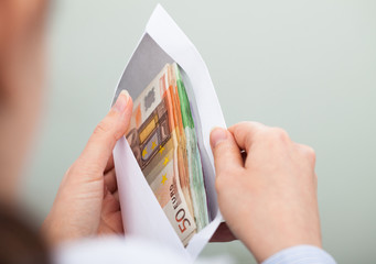 Person Checking Out Envelope With Cash