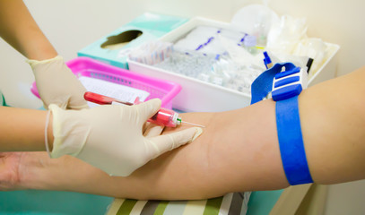 taking blood sample from patient at the doctor's office