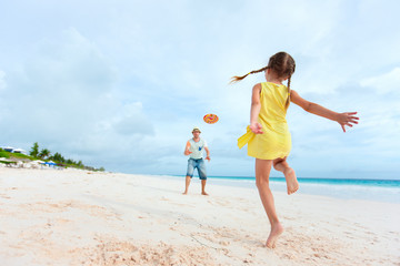 Father and daughter playing with flying disk