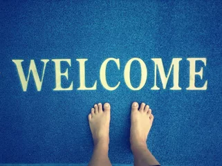 Foto op Canvas Doormat and foot © Successo images