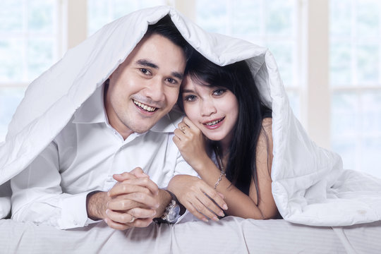 Attractive couple under blanket
