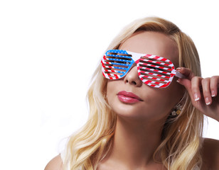 Blonde Girl with American Flags Sunglasses. Smiling Young Woman