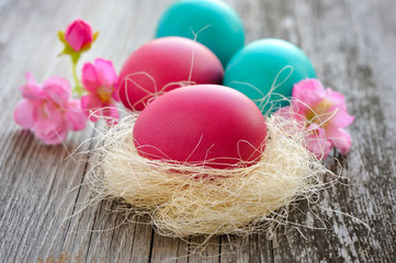 Colorful easter eggs on old wooden table