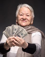 Old woman holding money in hands