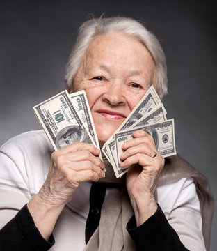 Old Woman Holding Money In Hands