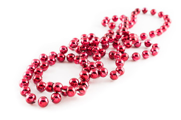 Mardi Gras party red beads placed in white background