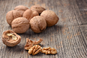Nuts placed on a wooden texture in natural light