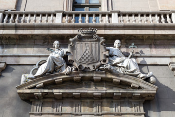Two maidens on the facade of an old building