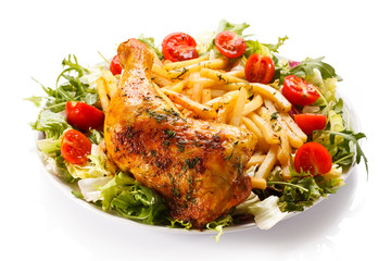 Grilled chicken leg with chips and vegetables