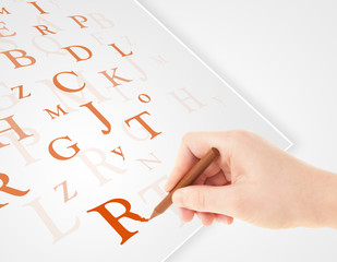 Hand writing various letters on white plain paper