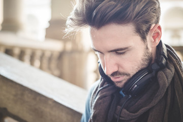 young handsome man listening to music with headphones