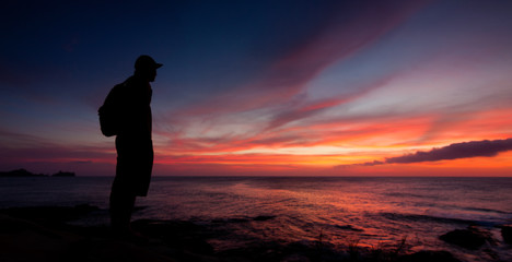 Silhouette of a man watching the sunset
