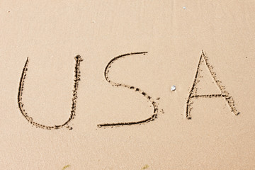 USA, written on a sandy beach