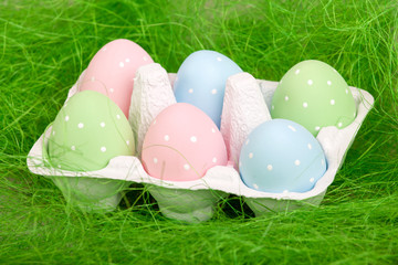 pastel colored easter eggs in cardboard